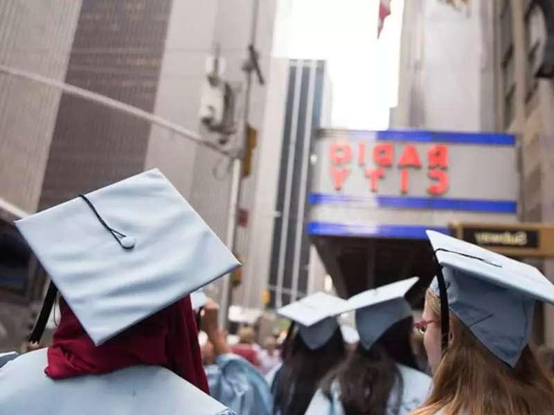 Barnard grads in graduation regalia, headed to Radio City